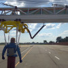 A crash test dummy used in a crash avoidance test systems, hangs from a MacBUILT actuator mounted to a cantilevered MacFRAME structure.
