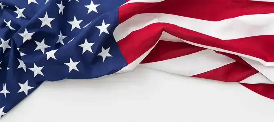 American flag with bold text stating ‘We Are Tariff-Free’ – Macron Dynamics announces no tariff impact on U.S.-made automation solutions.